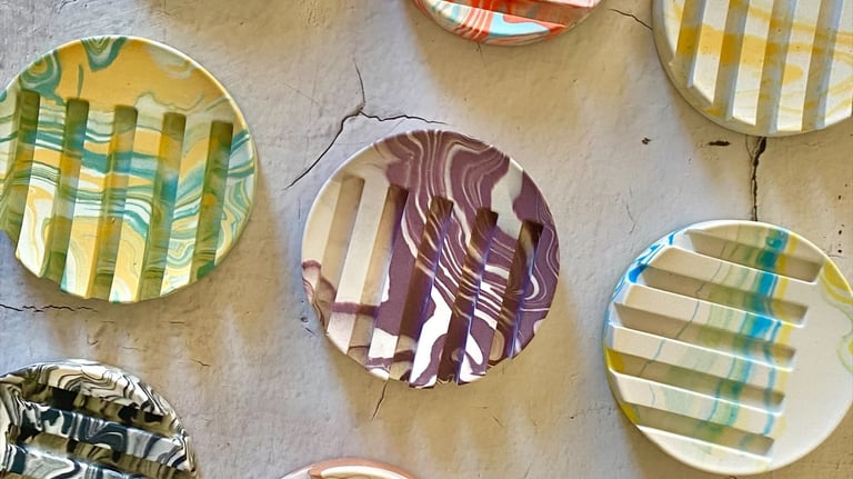 round jesmonite soap dishes in variety of colours and marbling effect