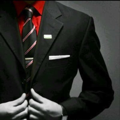 a man in a suit and tie with a red tie