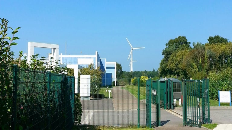a gated in area with a fenced in area with a wind turbine