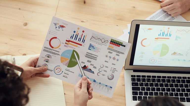 a group of people sitting around a table with papers and papers