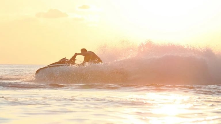 Jetski turning in evening sunlight in the ocean