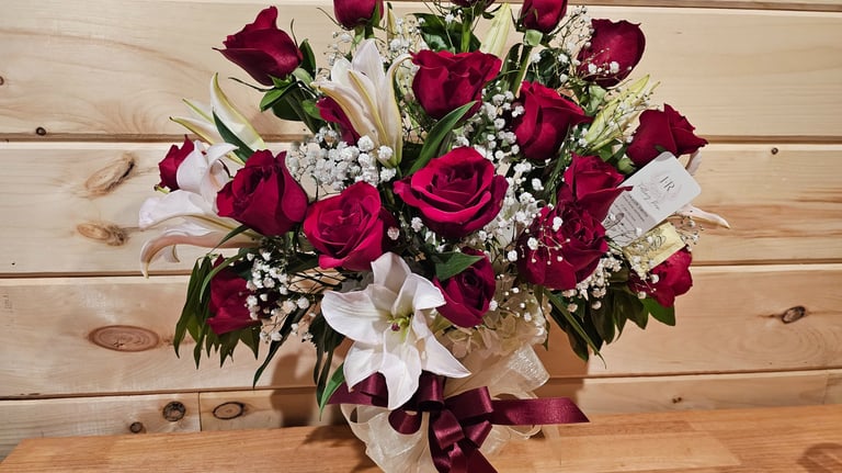 a bouquet of red roses in a vase on a table