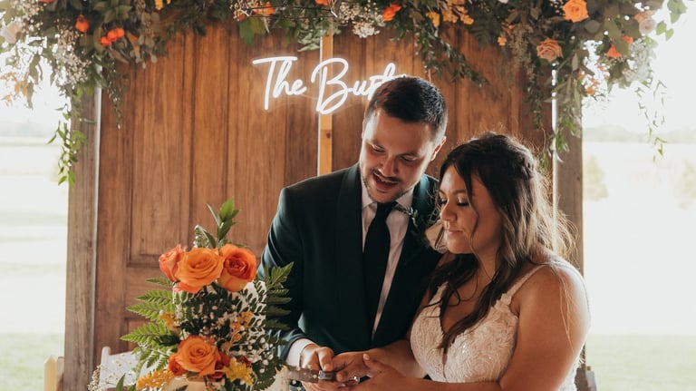 a bride and groom cutting their wedding cake