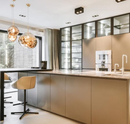 a kitchen with a large island and a bar stool