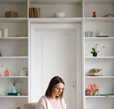 a woman sitting on a couch in a living room
