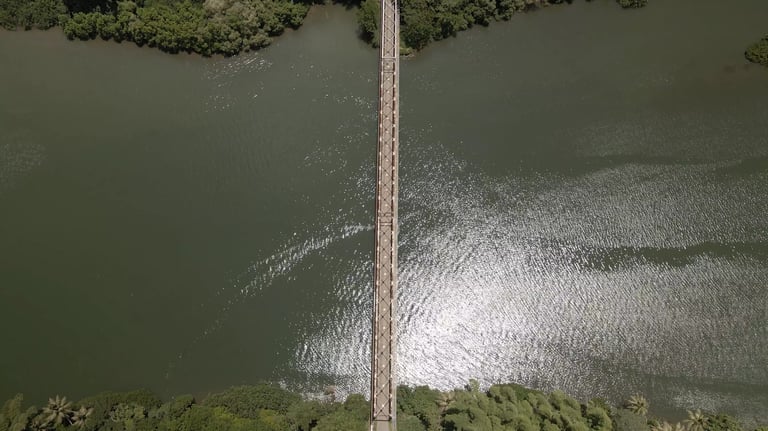 a bridge spanning a river with a bridge in the middle