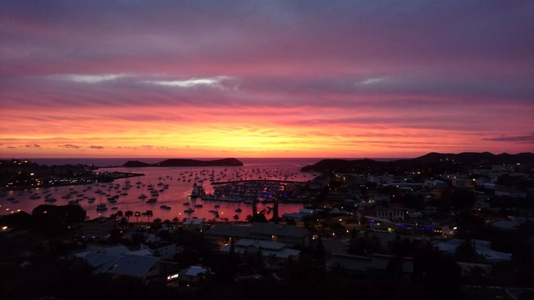 a sunset over a harbor with boats in the water