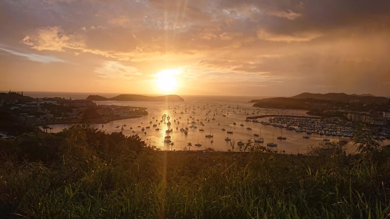 a sunset over a body of water with boats