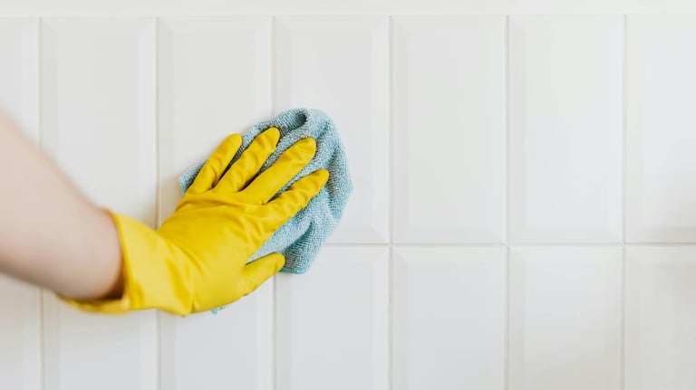 Detail of grout line being deep-cleaned between white tiles