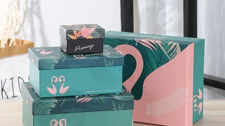 a stack of three boxes with a pink flamingo on top