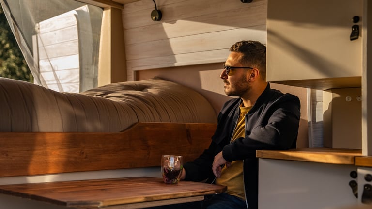 a man sitting at a table with a drink