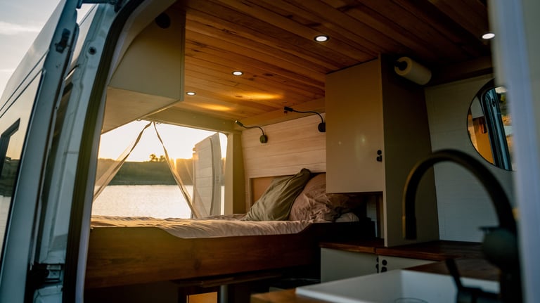 a camper van with a bed and a bed in the back