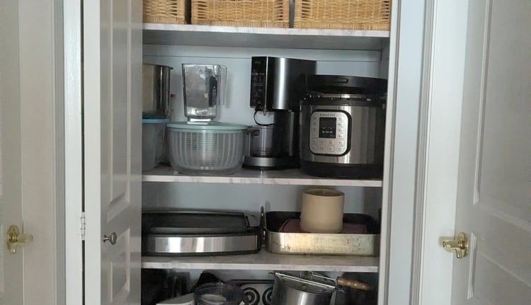 Organized kitchenware closet with strong shelving