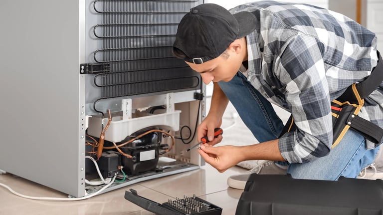 a person repairing a fridge