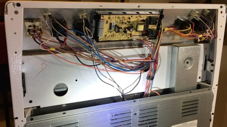 back panel of a range is removed for diagnostic and repair