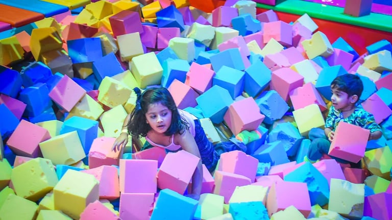 a child's play area with a large pile of colorful blocks