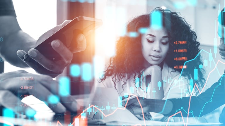 a woman is looking at her phone while she is working on her laptop