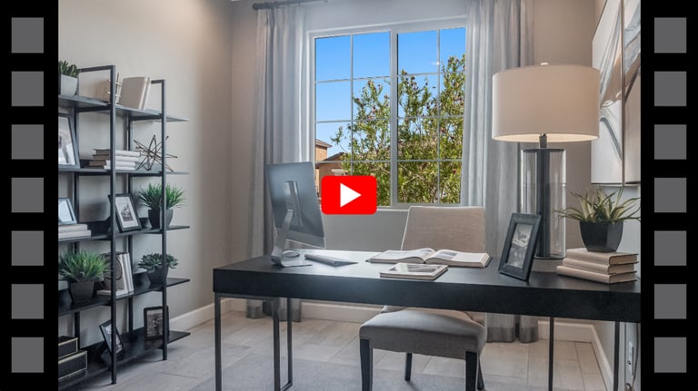 a desk with a laptop and a lamp