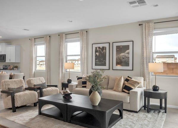 a living room with a couch and chairs