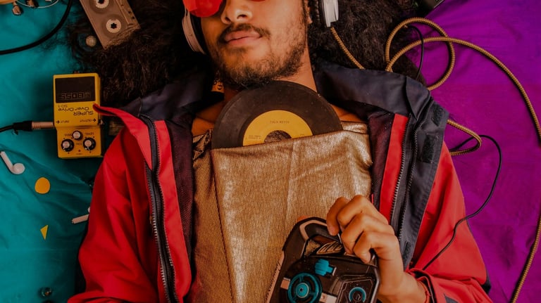 a man with a guitar and a gaming headpphone