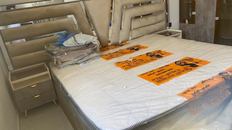 a bed with a mattress and a bed in a room