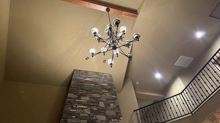 a chandelier in a high foyer