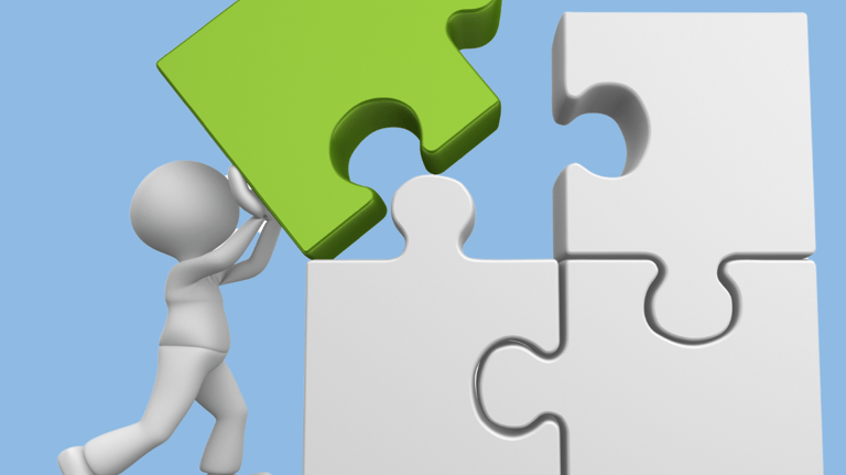 a person is holding a piece of puzzle