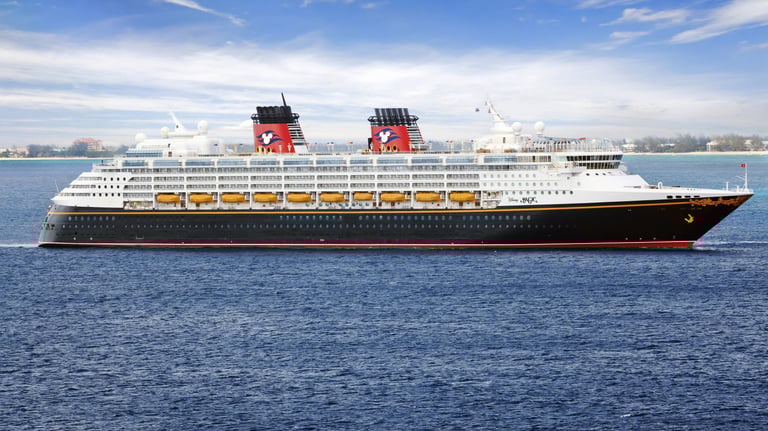 A gargantuan Disney Cruise ship, with a red, yellow, and black color scheme evoking Mickey Mouse
