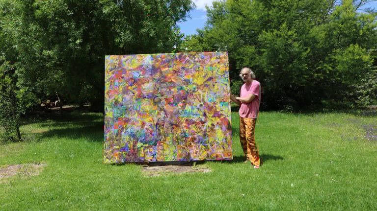Artist standing with large oil painting on Belgian linen in garden 