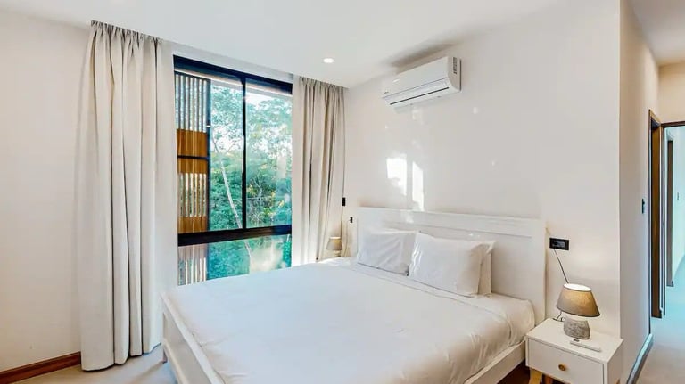 a bedroom with a bed and a window