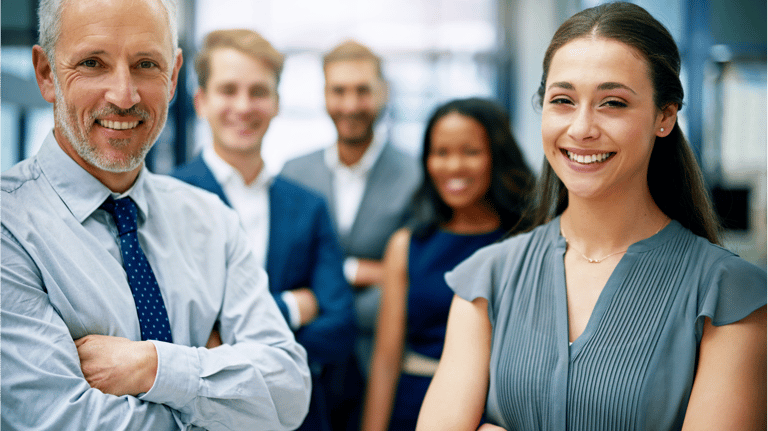 a man and woman standing in front of a group of people