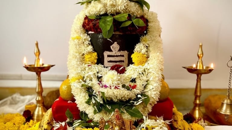 Sacred puja setup with kalash, flowers, and diya