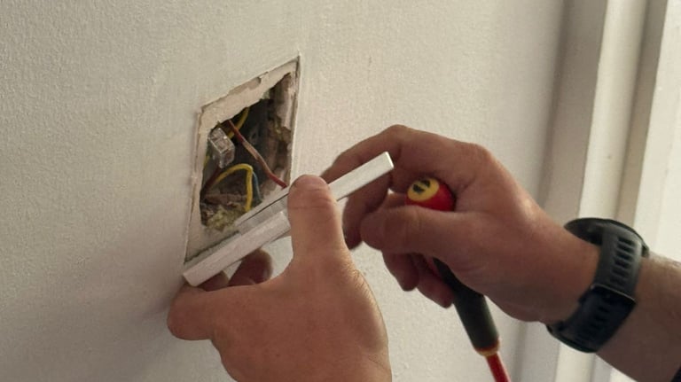 Electrician fixing a light switch in Norwich