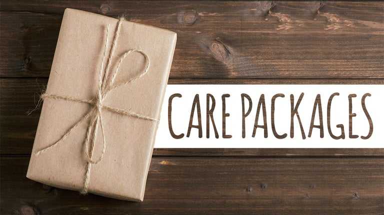 Brown kraft paper care package wrapped in twine on a rustic wood background.