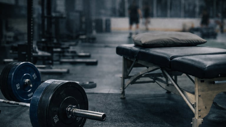 a gym room with a bench and a bench with a barbell