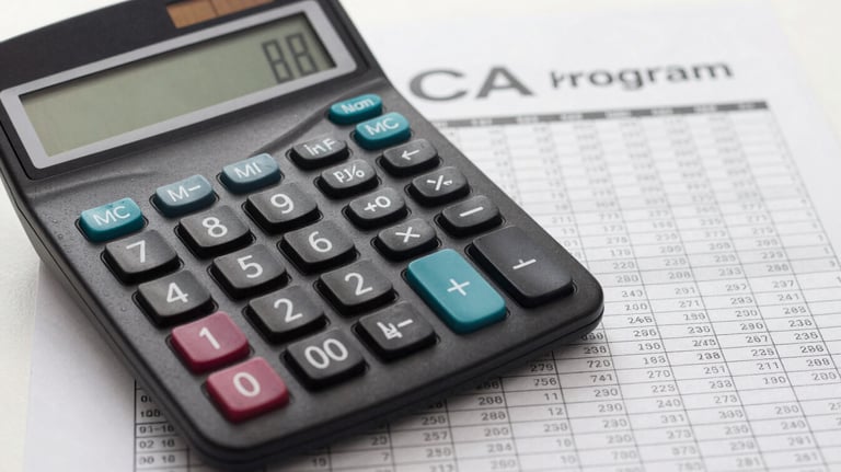 A close-up photograph of a calculator and a financial ledger on a Soft White desk, symbolizing the precision of the Commerce and CA program.