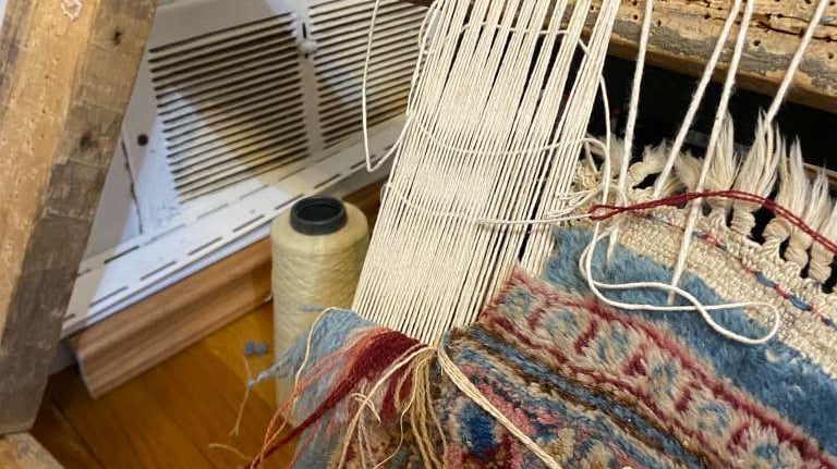 Professional rug repair and restoration with hand weaving and fringe reconstruction.