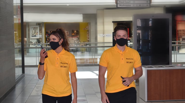 Two Security Guard inside the building inspecting the areas