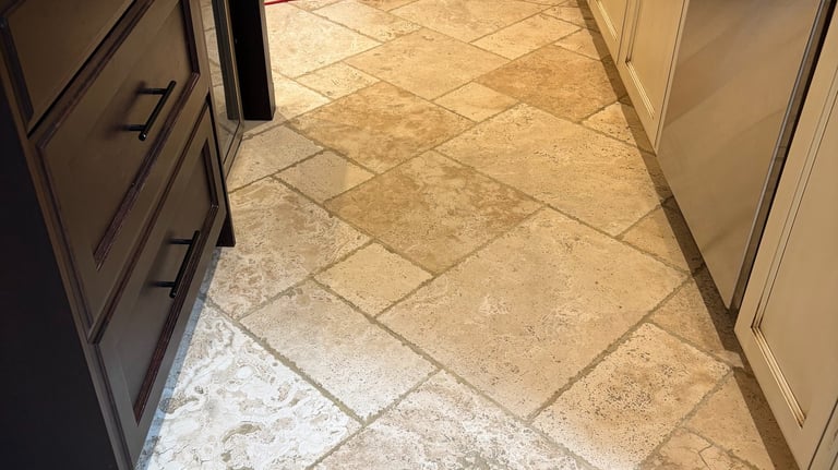 Clean and restored travertine kitchen floor after professional cleaning