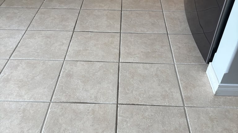 Dirty ceramic tile floor in kitchen before professional cleaning