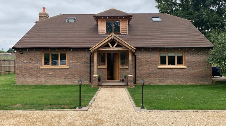 A new build chalet bungalow with traditional brickwork and oak porch