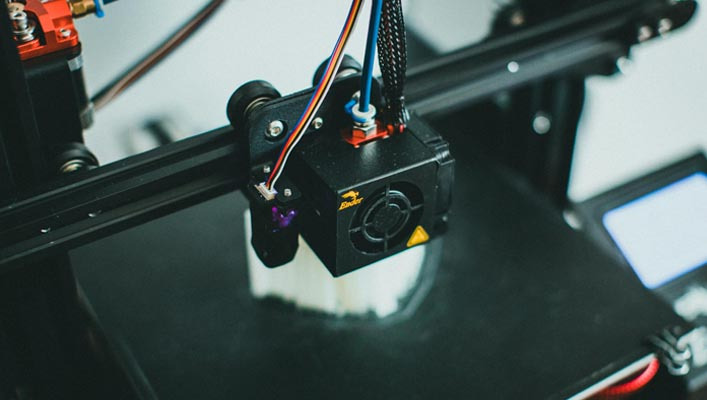 close up picture of a 3d printer printing a piece of art.