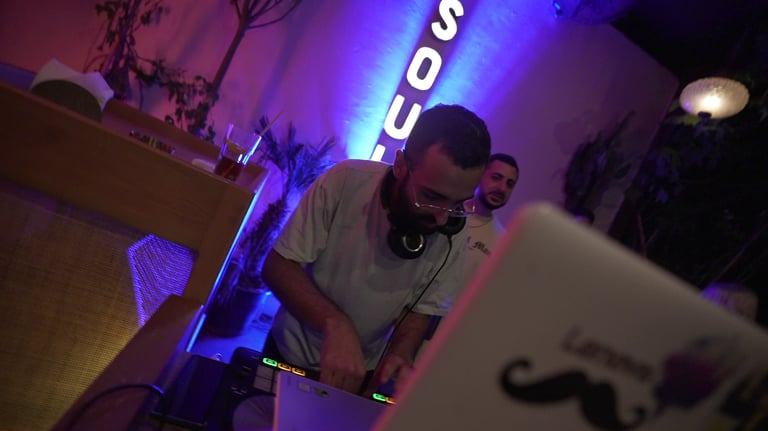 a man in a white shirt is djing for a hip hop party in beirut lebanon