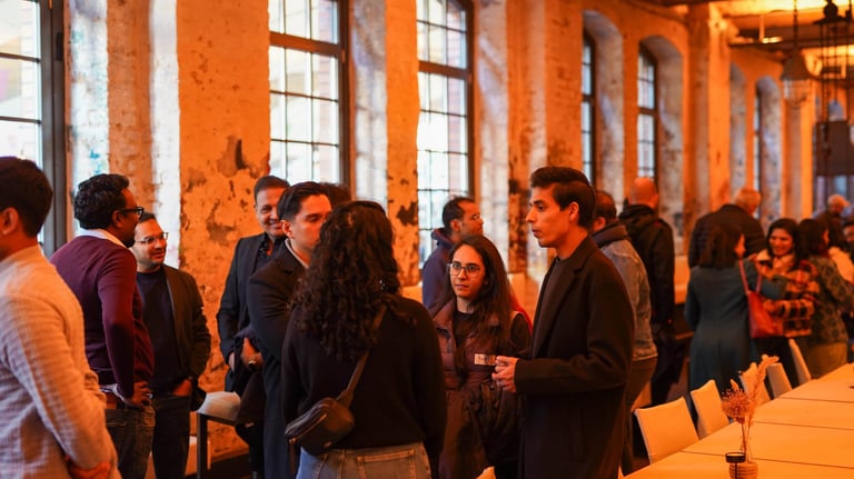 A group of people standing around a long table