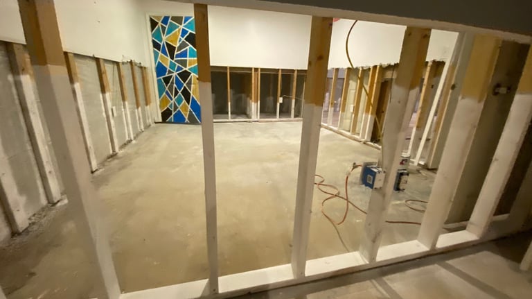 a room with a lot of unfinished walls and encapsulated wooden studs and a window