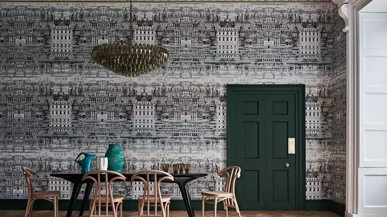 Modern dining room featuring architectural black and white wallpaper, a dark green door, and wooden chairs.