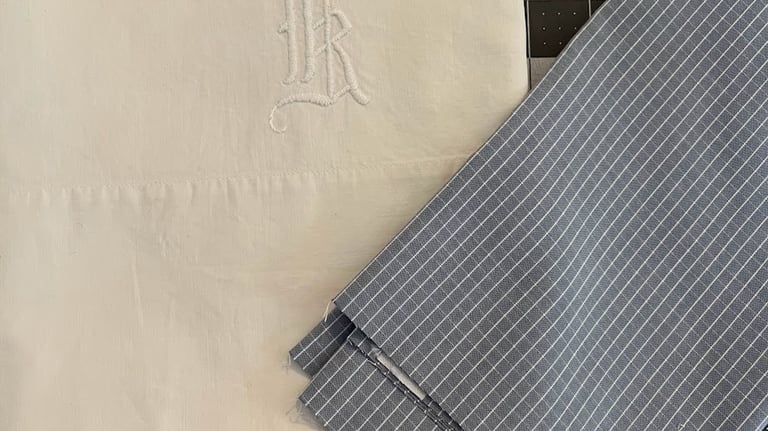 picture of an embroidered monogram pillowcase and the fabric used to make the back of a decorapillow