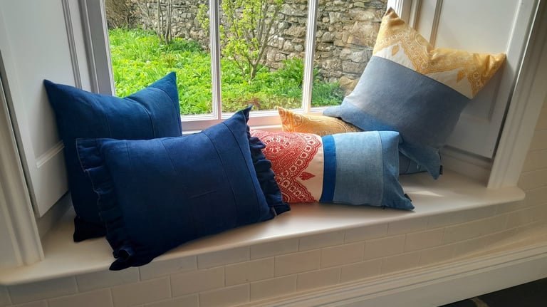 Repurposed vintage cushions on a classic Victorian window seat.