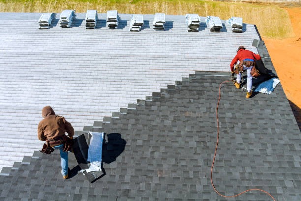sky view of 2 workers installing roof tiles
