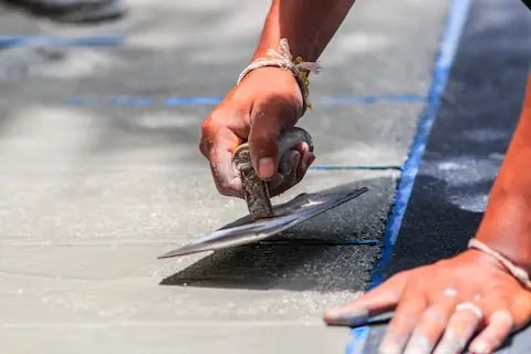 West Linn concrete contractor using trowel to smooth concrete repair